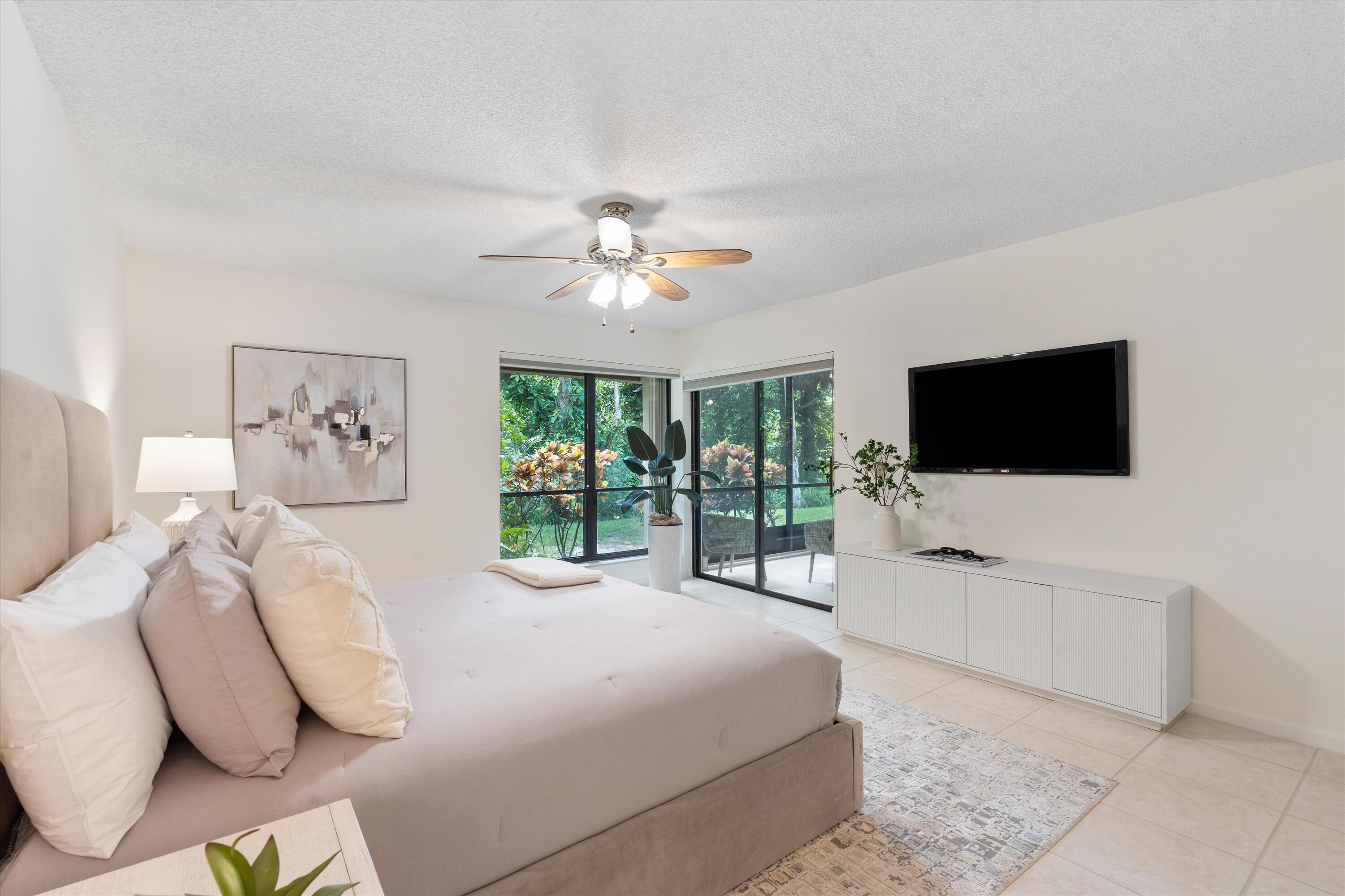 5620 Coach House Circle, Unit D Boca Raton, FL 33486 - Photo 15 of 27 Primary Bedroom with patio view