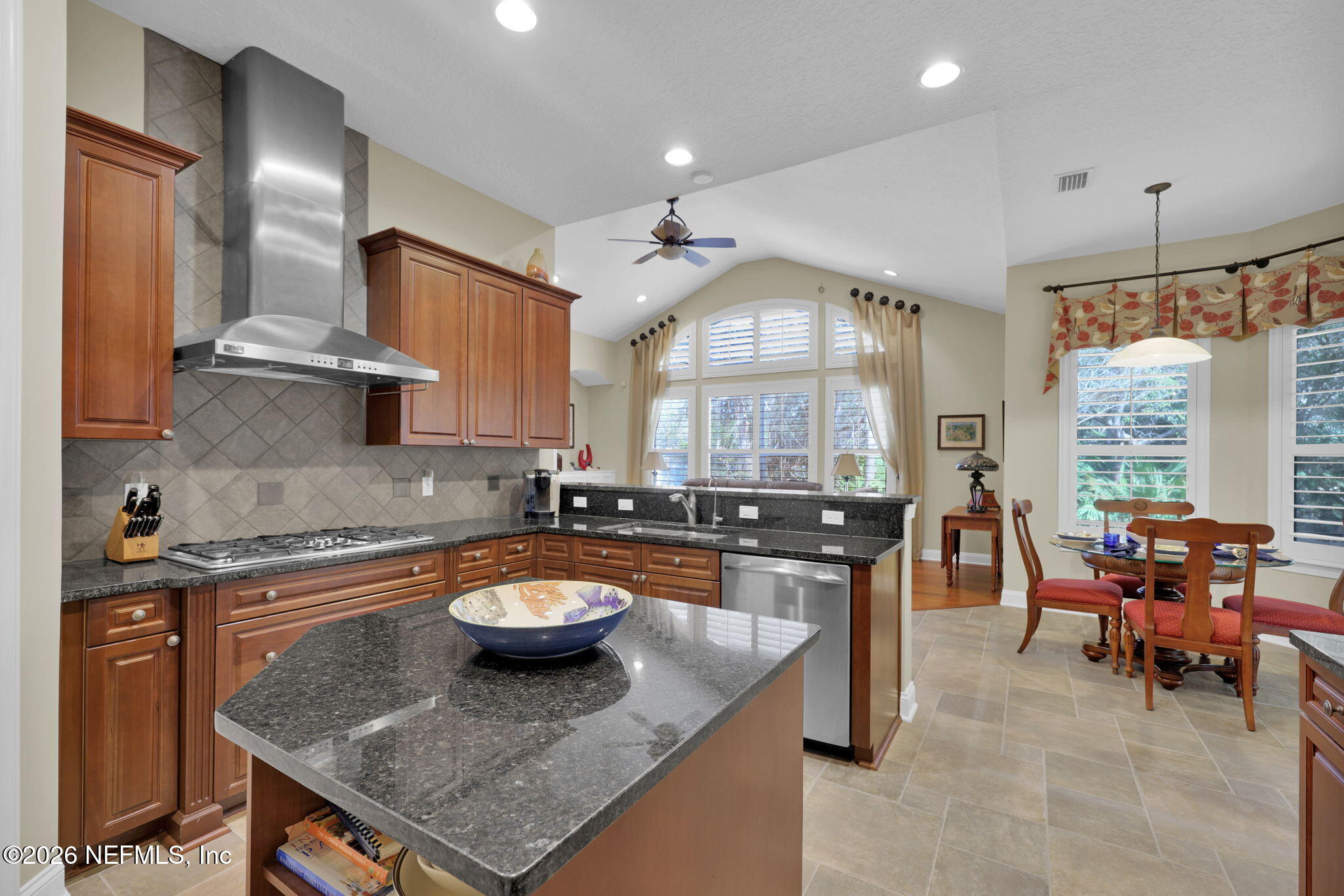 549 Sebastian Square St. Augustine, FL 32095 - Photo 11 of 51 a kitchen with a stove a sink a dining table and chairs