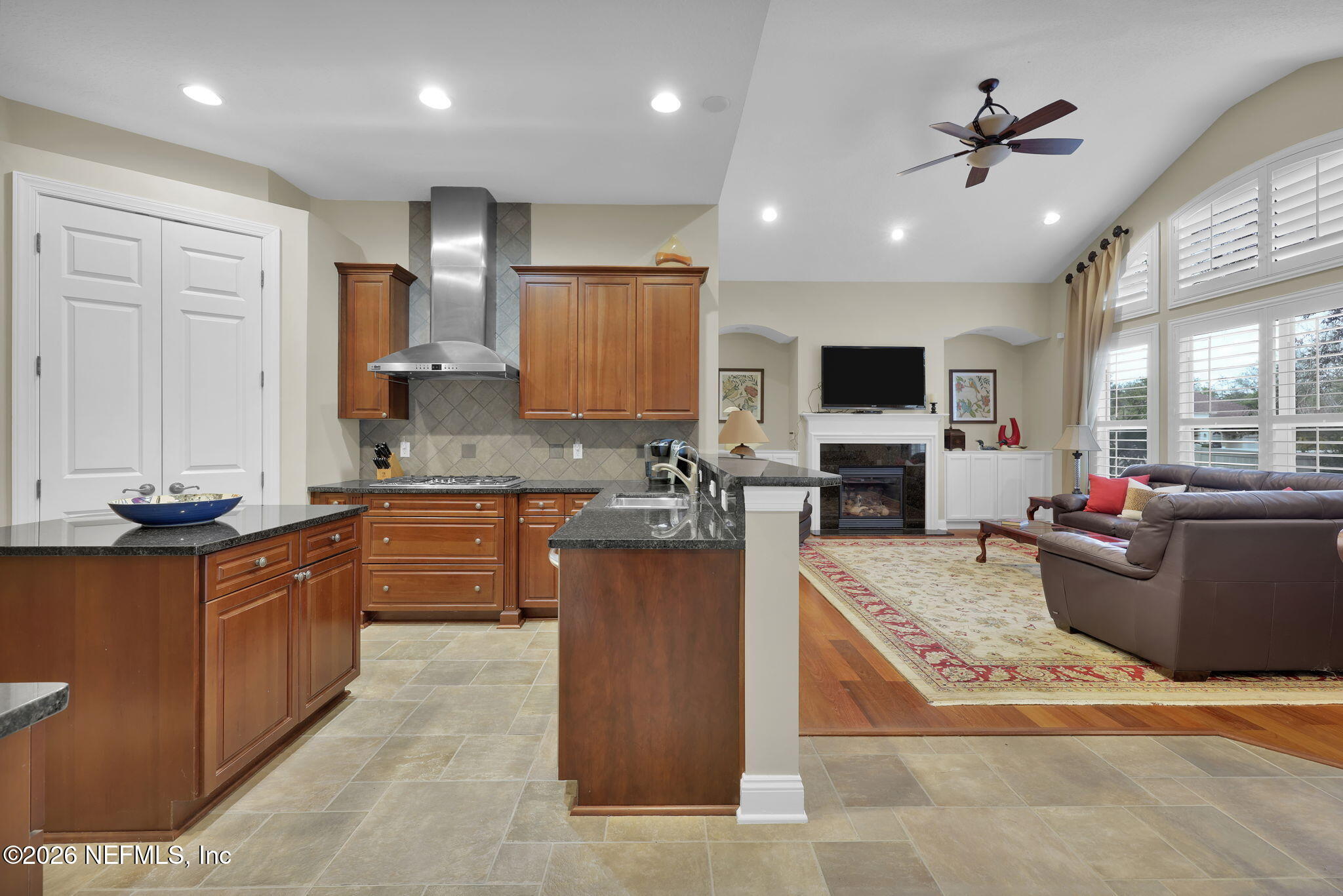 549 Sebastian Square St. Augustine, FL 32095 - Photo 13 of 51 a large kitchen with stainless steel appliances kitchen island granite countertop a sink dishwasher a stove and a refrigerator with wooden floor