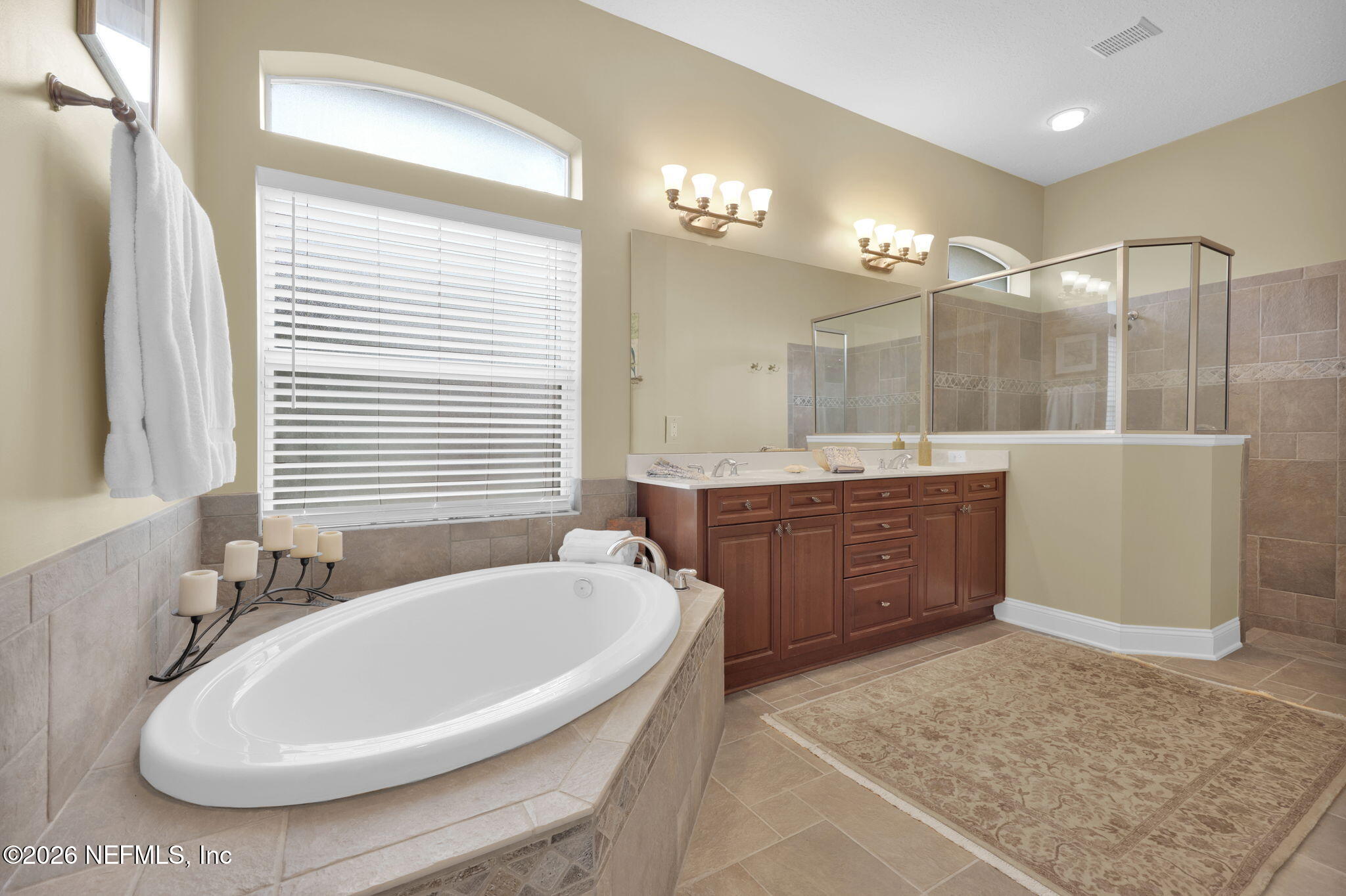549 Sebastian Square St. Augustine, FL 32095 - Photo 25 of 51 a bathroom with a tub a sink a mirror and a shower