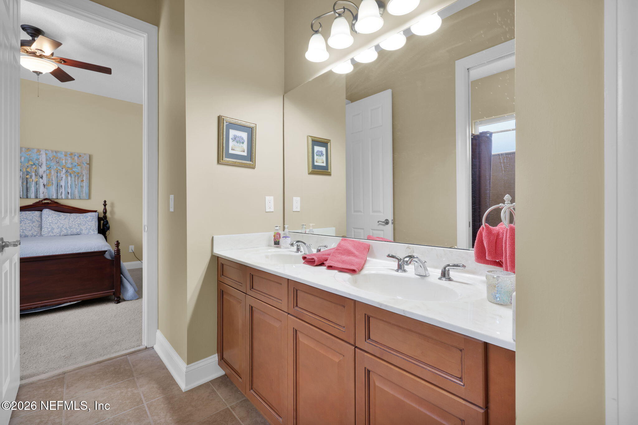 549 Sebastian Square St. Augustine, FL 32095 - Photo 27 of 51 a en suite bathroom with a sink and a mirror