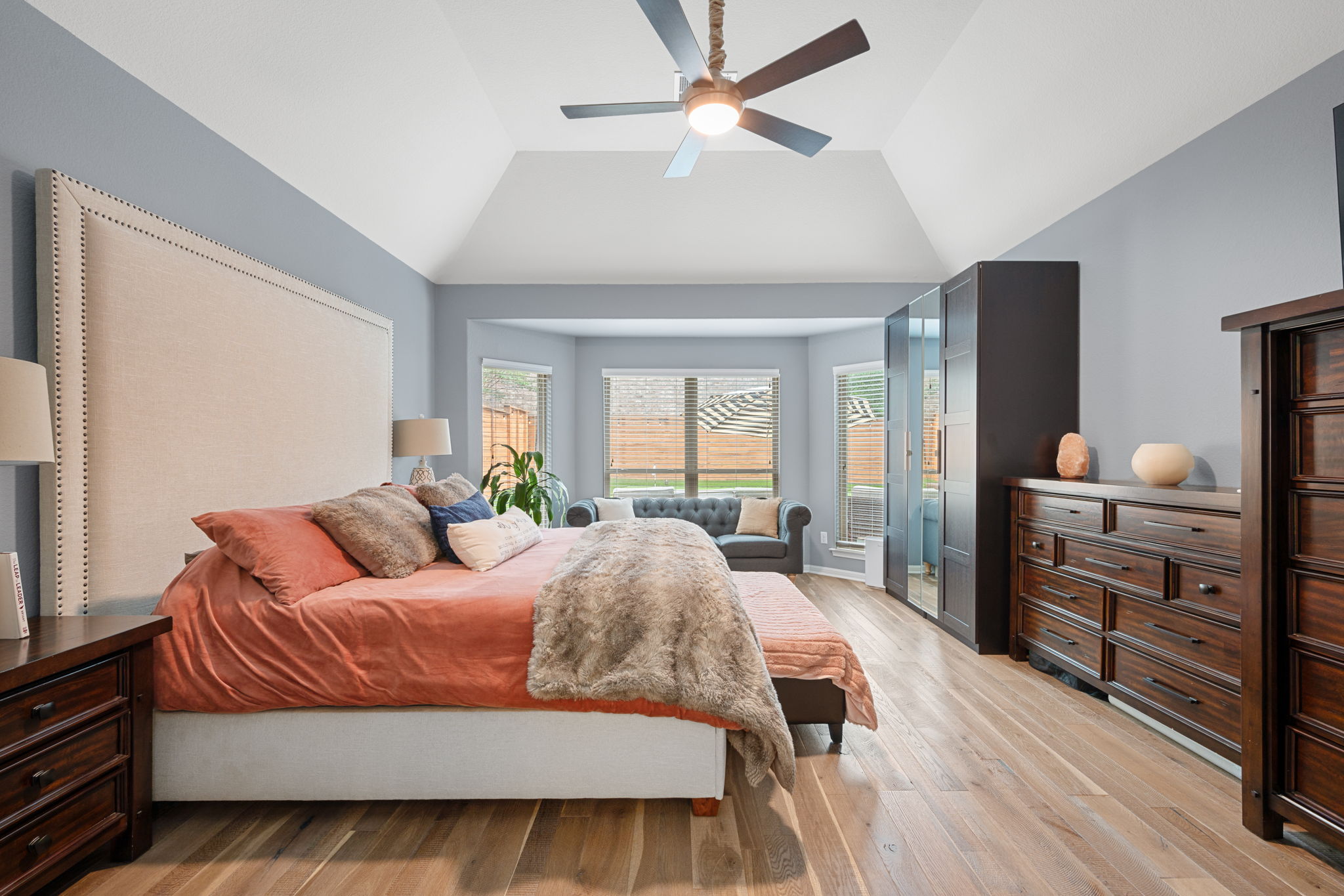 12109 Montclair Bend Austin, TX 78732 - Photo 17 of 39 Vaulted ceiling room featuring light wood-finish flooring, a contemporary ceiling fan with integrated lighting, and multiple windows