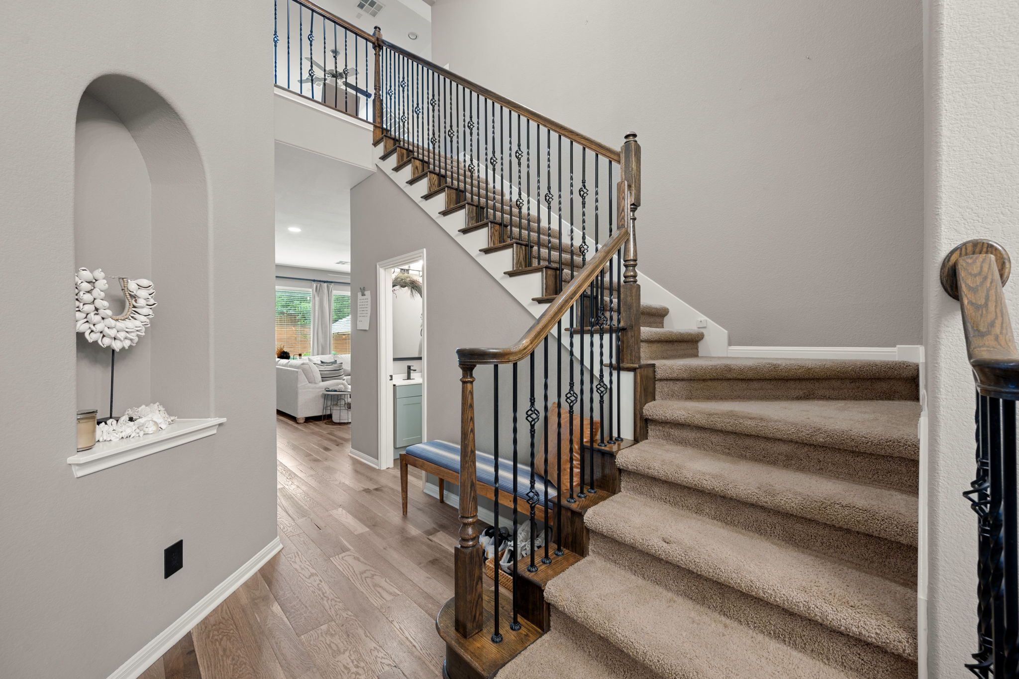 12109 Montclair Bend Austin, TX 78732 - Photo 20 of 39 Staircase featuring wood-finish handrails, decorative iron balusters, and carpeted treads