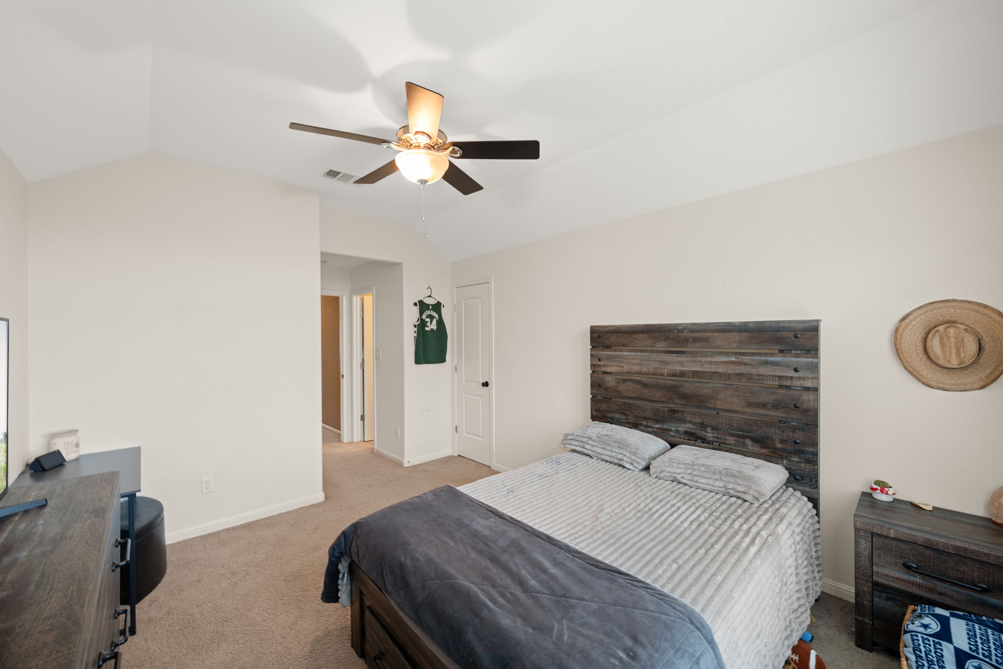 12109 Montclair Bend Austin, TX 78732 - Photo 25 of 39 Bedroom featuring light-colored walls, vaulted ceiling, and a ceiling fan with integrated lighting