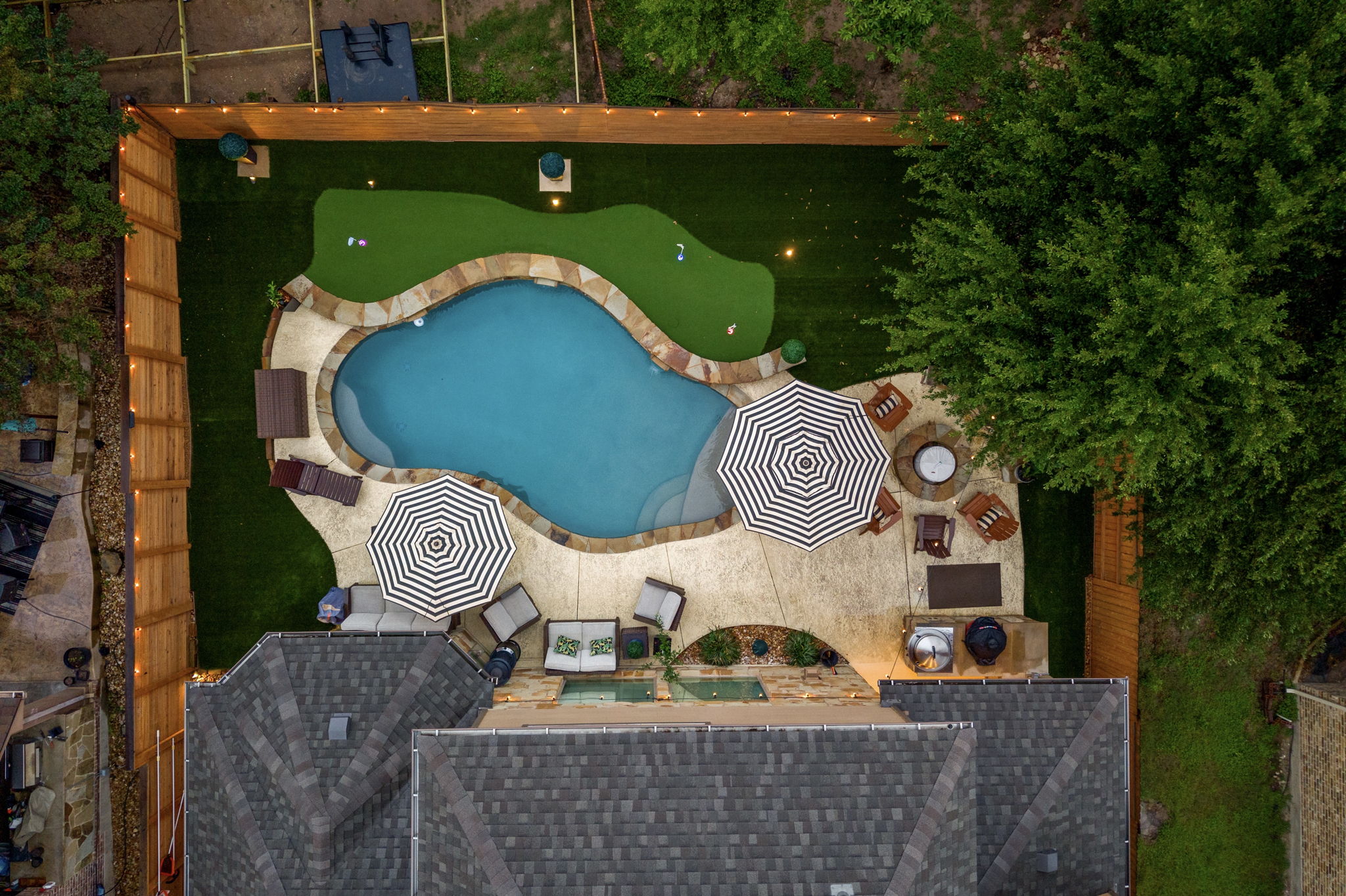12109 Montclair Bend Austin, TX 78732 - Photo 37 of 39 Backyard oasis featuring a freeform swimming pool with stone coping, an artificial turf putting green, and a concrete patio