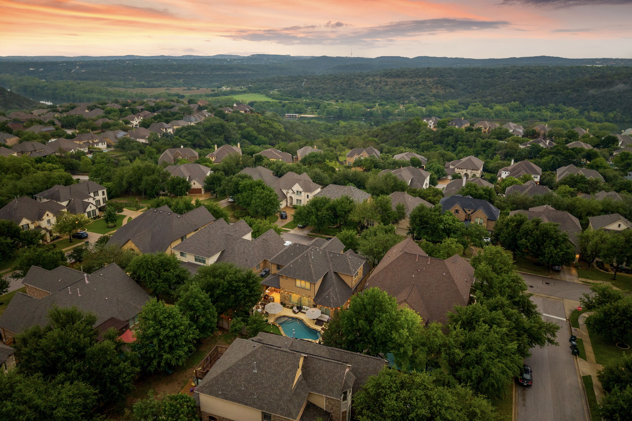 12109 Montclair Bend Austin, TX 78732 - Photo 38 of 39 Aerial perspective showcasing a residential community nestled among abundant mature trees and rolling hills