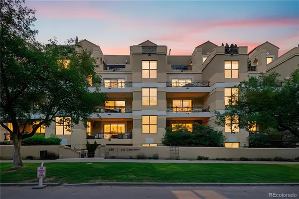 a front view of a residential apartment building with a yard