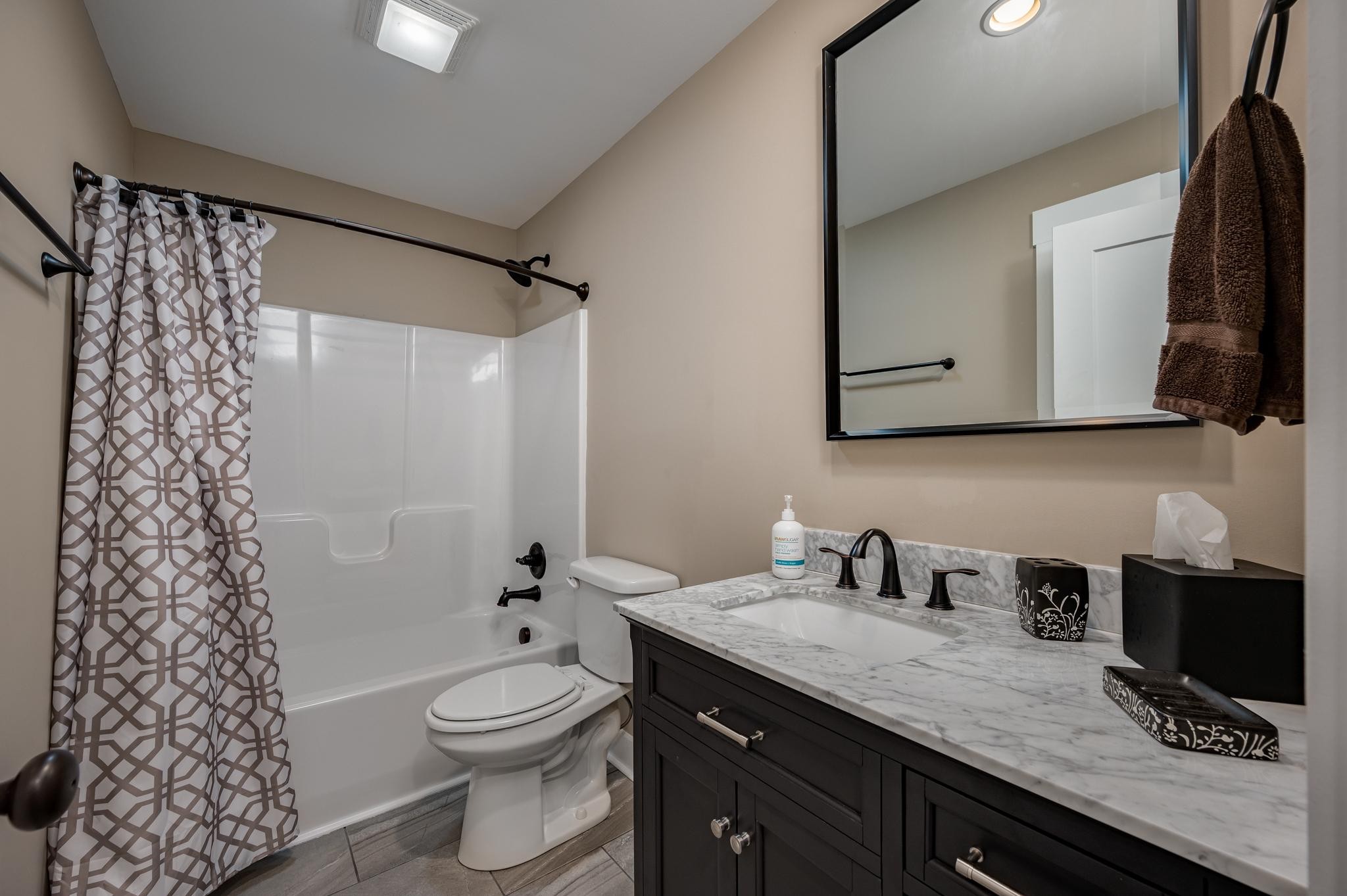28 Taylor Road Manchester, TN 37355 - Photo 19 of 27 a bathroom with a granite countertop sink a toilet a mirror and shower