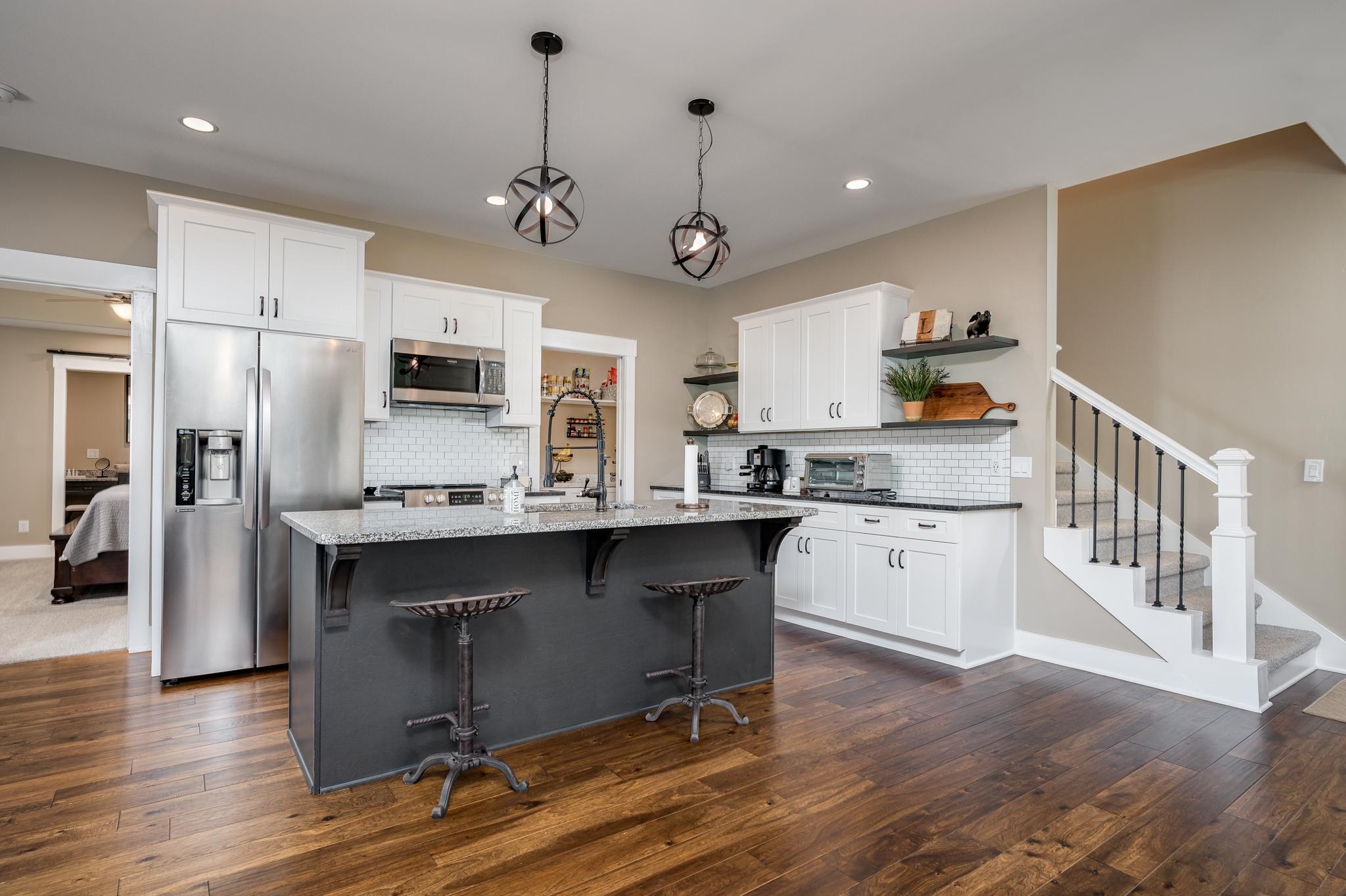 28 Taylor Road Manchester, TN 37355 - Photo 9 of 27 a kitchen with stainless steel appliances granite countertop a refrigerator a sink dishwasher a stove and white cabinets with wooden floor