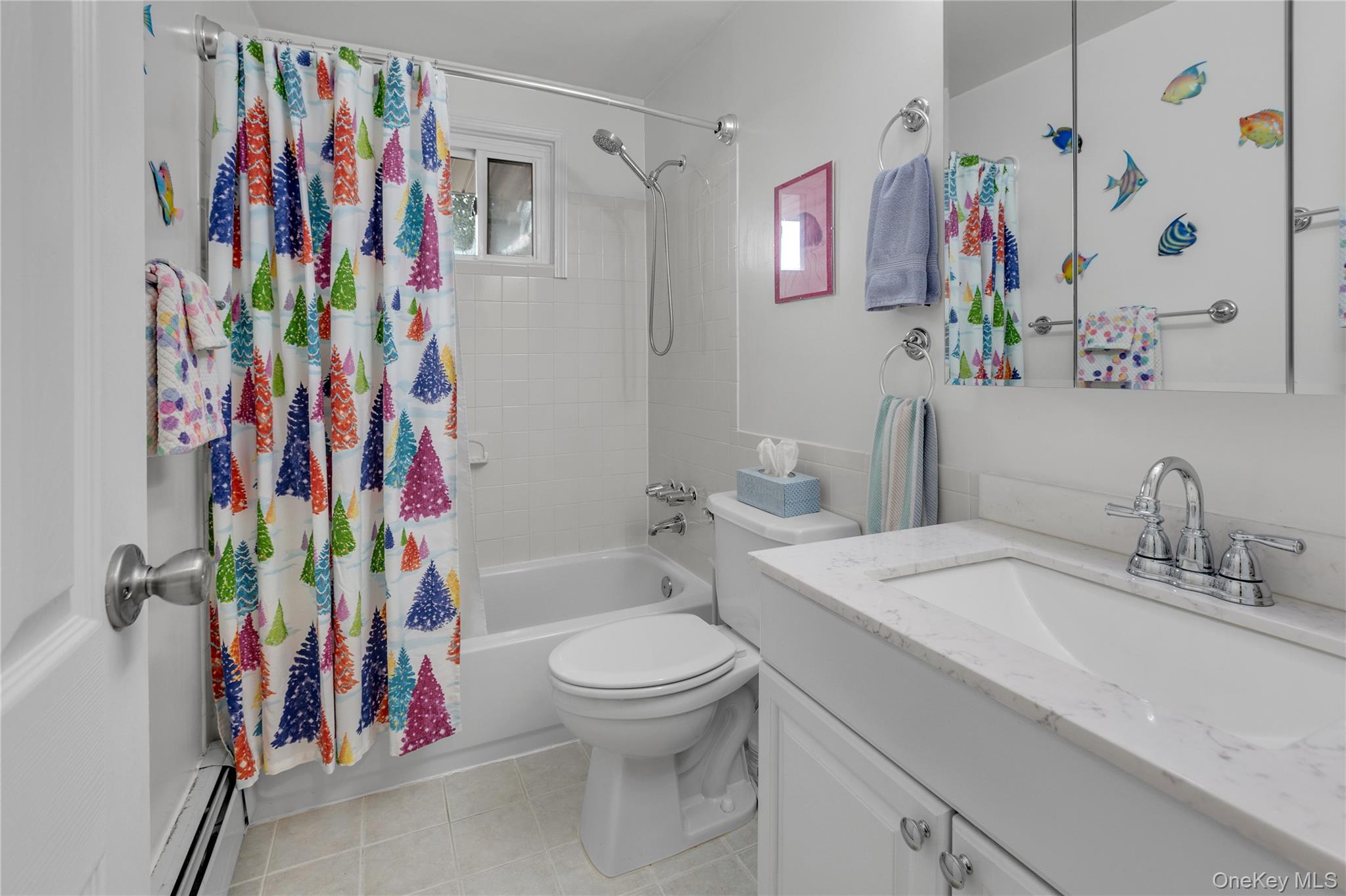 200 Merrick Road, Unit I Amityville, NY 11701 - Photo 11 of 12 Bathroom with vanity, shower / bath combination with curtain, a baseboard radiator, and light tile patterned floors