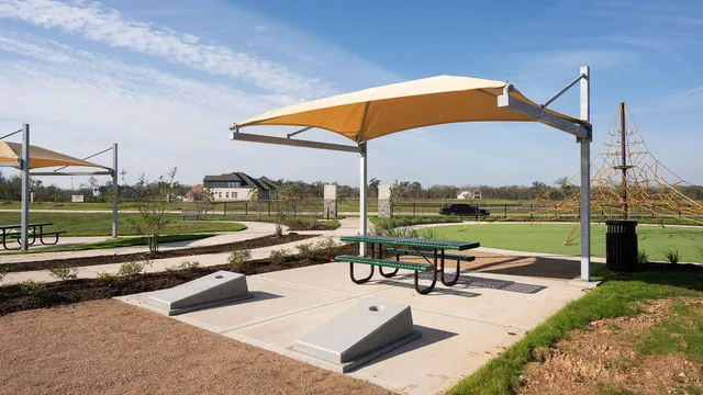 a view of a swimming pool with a table and chairs under an umbrella
