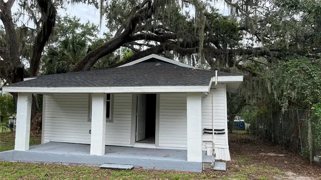 a house that has a tree in front of the house