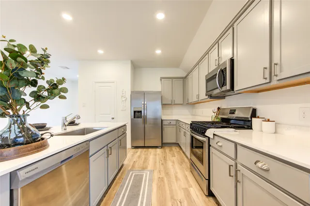 a kitchen with a sink stove and cabinets