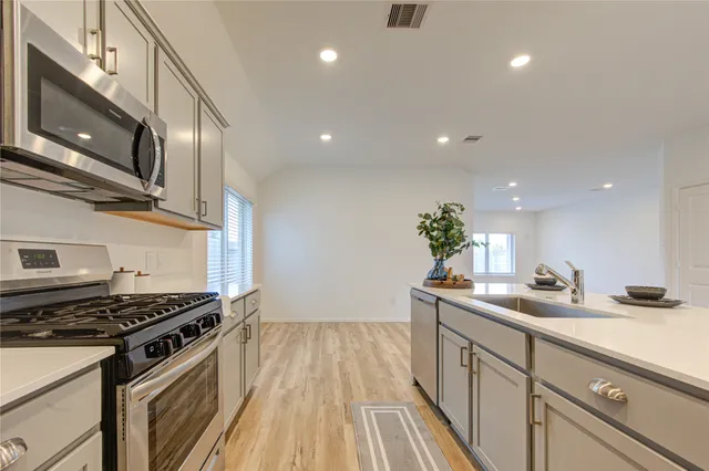 a kitchen with a sink and refrigerator