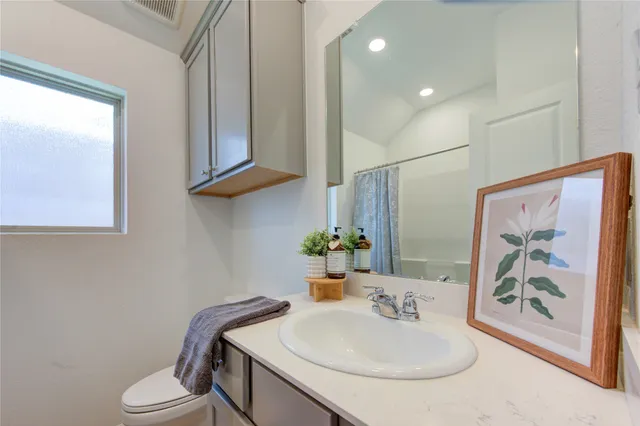 a bath room with a sink and a mirror