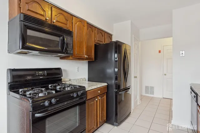 a kitchen with stainless steel appliances and granite countertop a stove top oven