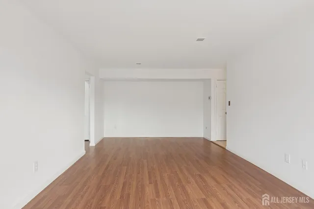 a view of a room with wooden floor