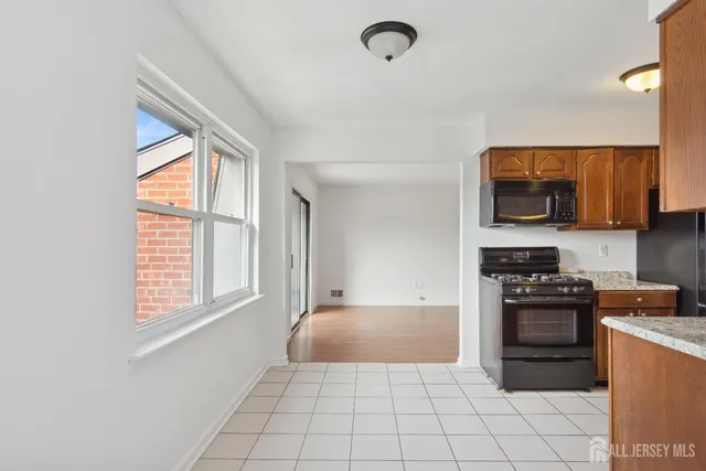 a kitchen with stainless steel appliances a stove sink and cabinets