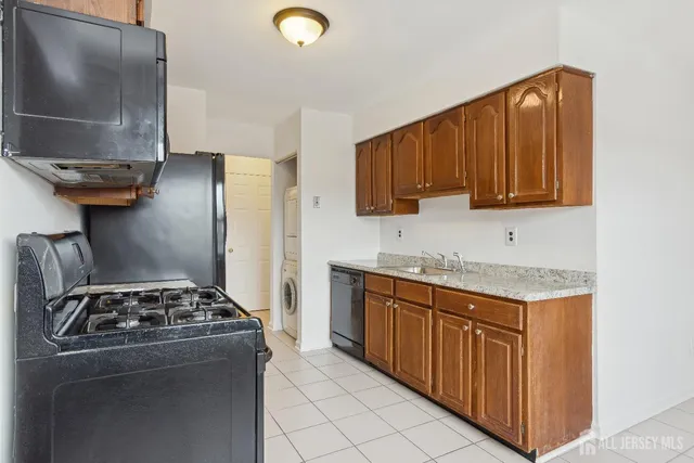 a kitchen with stainless steel appliances granite countertop a stove and a refrigerator