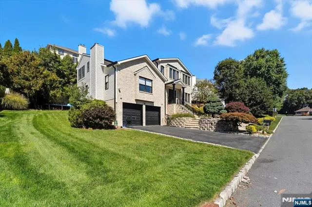 a view of a house with a patio and a yard