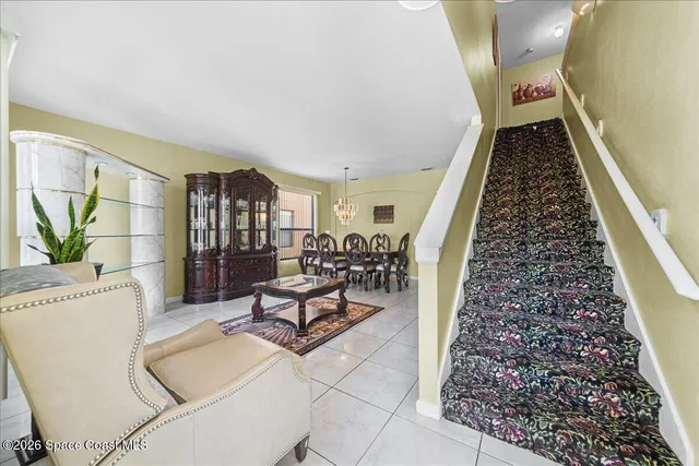 a view of a livingroom with wooden floor and furniture