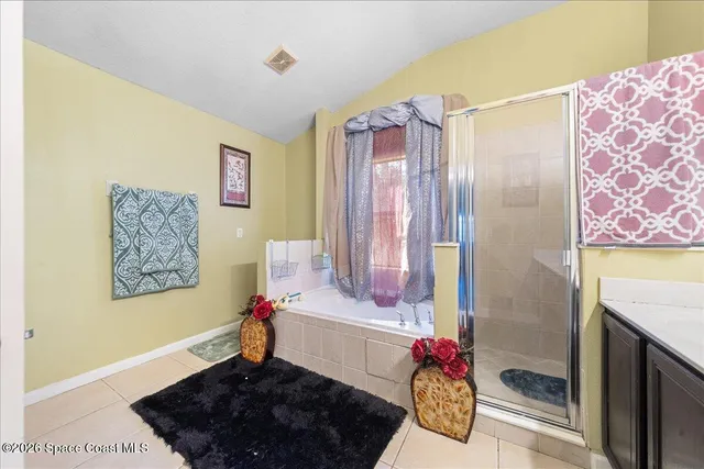 a bedroom with furniture and a wooden floor