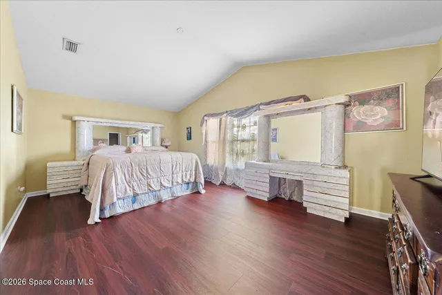 a bedroom with a bed and a chair