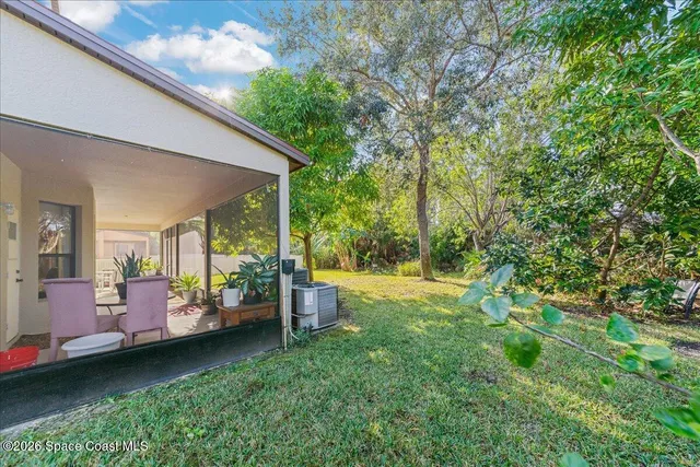 a backyard of a house with yard and outdoor seating