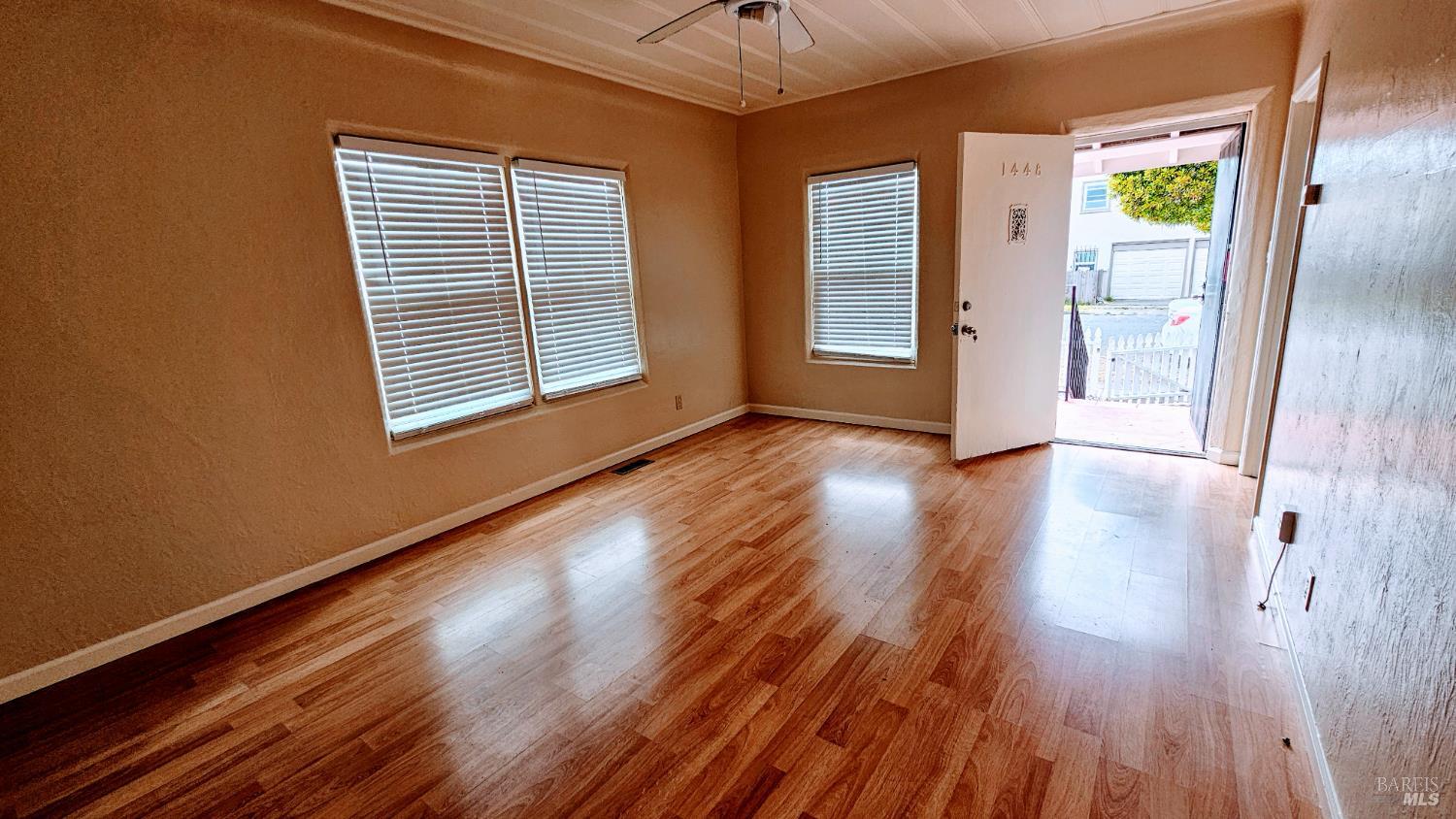 1448 Rice Street, Unit A Vallejo, CA 94590 - Photo 7 of 8 a view of an empty room with wooden floor and a window