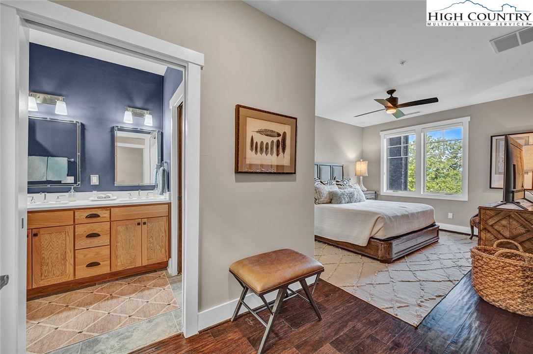 188 Ramblestone Terrace, Unit 101 Boone, NC 28607 - Photo 20 of 48 a spacious bedroom with a bed and a dresser in it