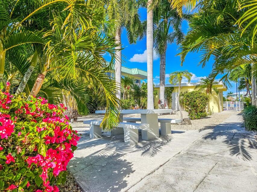 109 Ave D, Unit 305 Marathon, FL 33050 - Photo 34 of 41 a view of a patio with table and chairs and potted plants