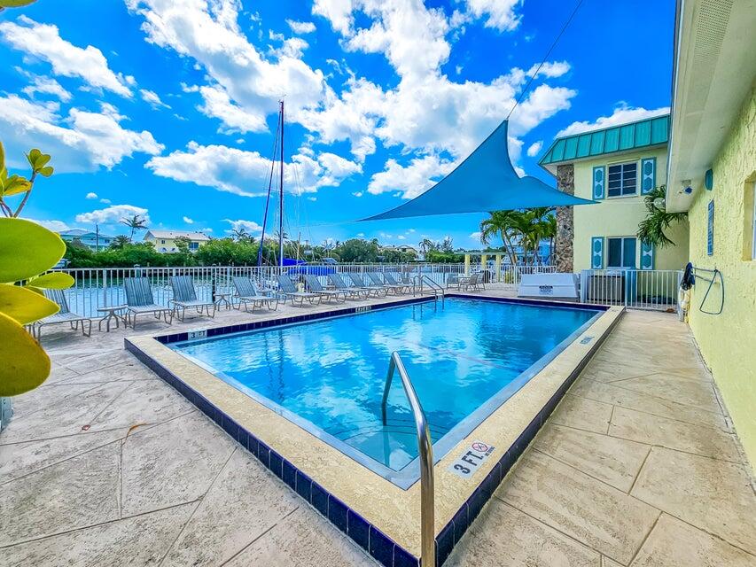 109 Ave D, Unit 305 Marathon, FL 33050 - Photo 5 of 41 a view of a swimming pool with a patio
