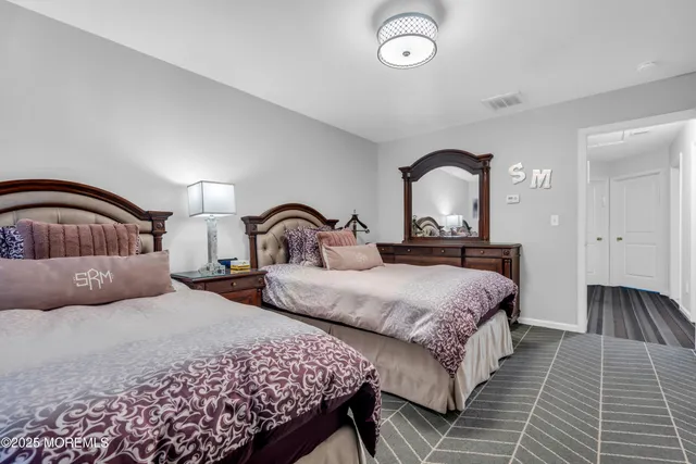 a bathroom with a granite countertop sink toilet and a mirror