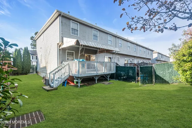 a view of a house with a yard patio and a slide
