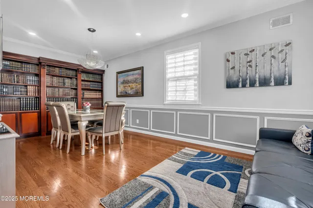 a dining room with furniture and wooden floor