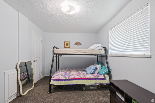 553 North 200 West Bountiful, UT 84010 - Photo 21 of 26 Bedroom featuring dark colored carpet and a textured ceiling