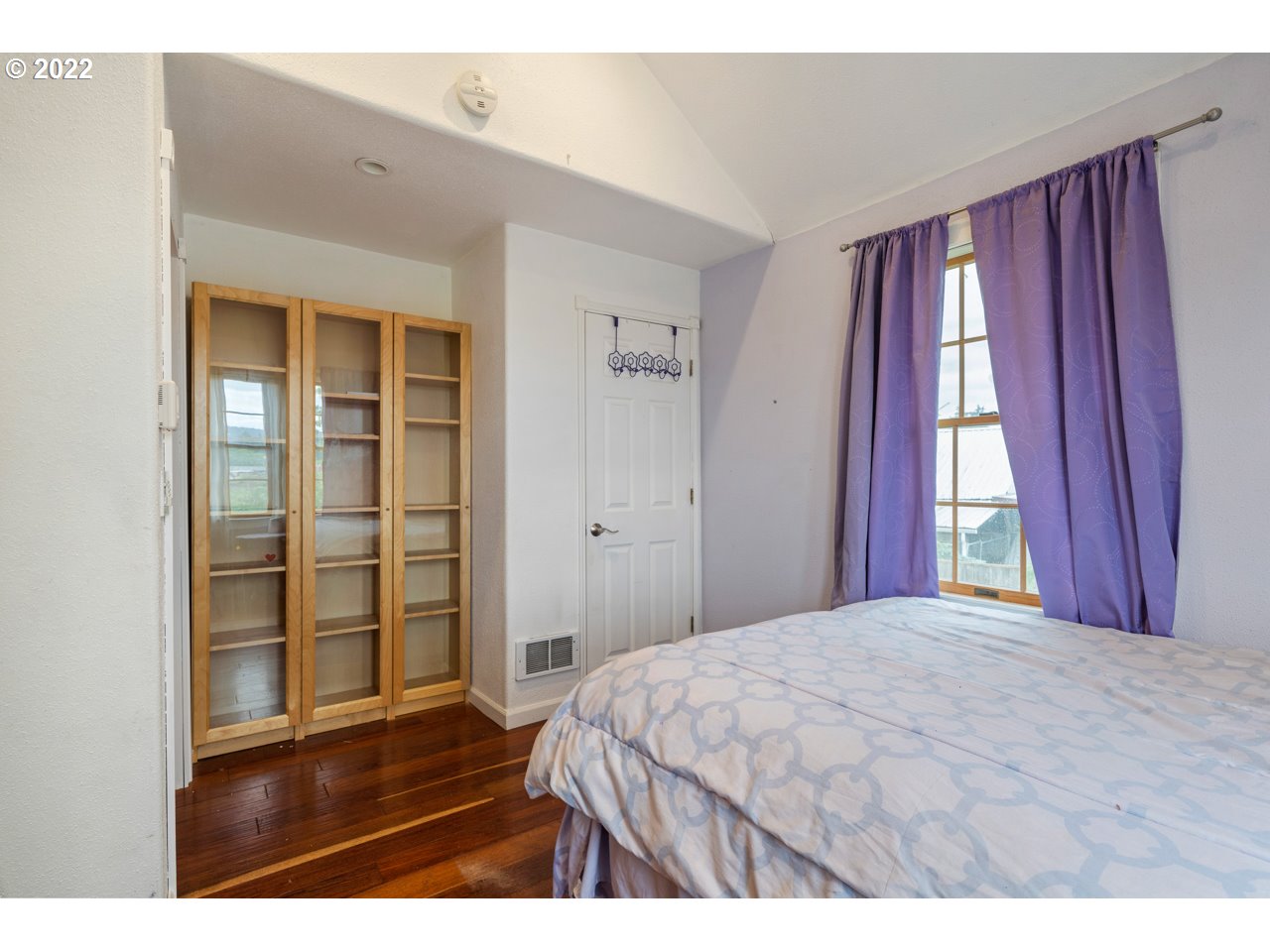 8480 Northeast Dog Ridge Road Newberg, OR 97132 - Photo 23 of 30 a bedroom with a bed and wooden floor