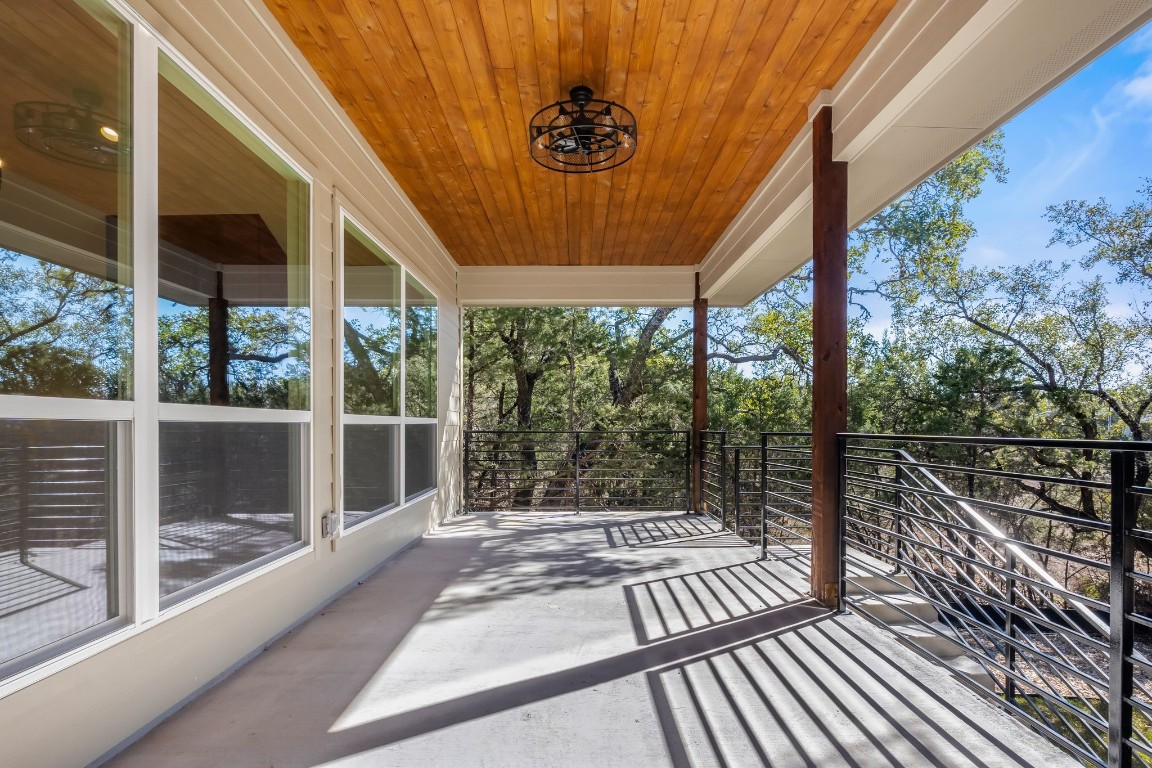 300 Bedford Drive Spicewood, TX 78669 - Photo 22 of 37 a view of a balcony with a large window and wooden floor