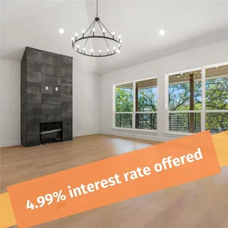 a view of an empty room with a fireplace and a window