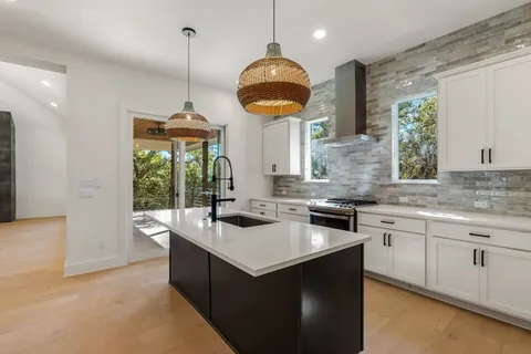 a kitchen with granite countertop a sink and a stove