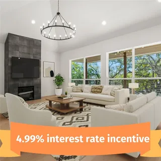 a living room with fireplace furniture and a large window