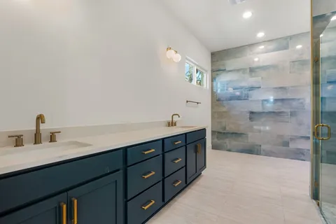a spacious bathroom with a shower sink and mirror