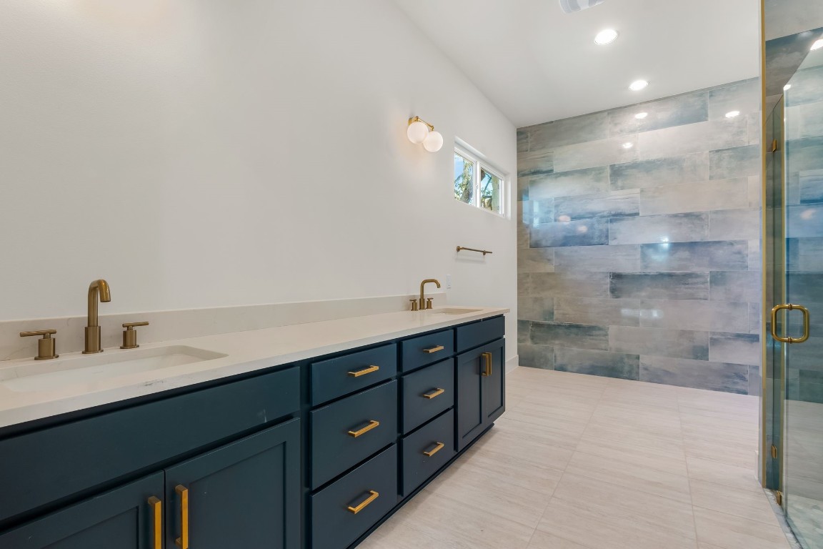 300 Bedford Drive Spicewood, TX 78669 - Photo 10 of 37 a spacious bathroom with a shower sink and mirror