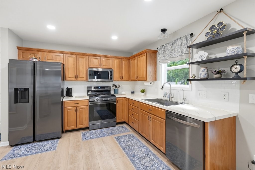 851 Susan Road Ravenna, OH 44266 - Photo 21 of 50 Kitchen featuring light wood cabinetry, stainless steel appliances, white subway tile backsplash, and light-toned countertops