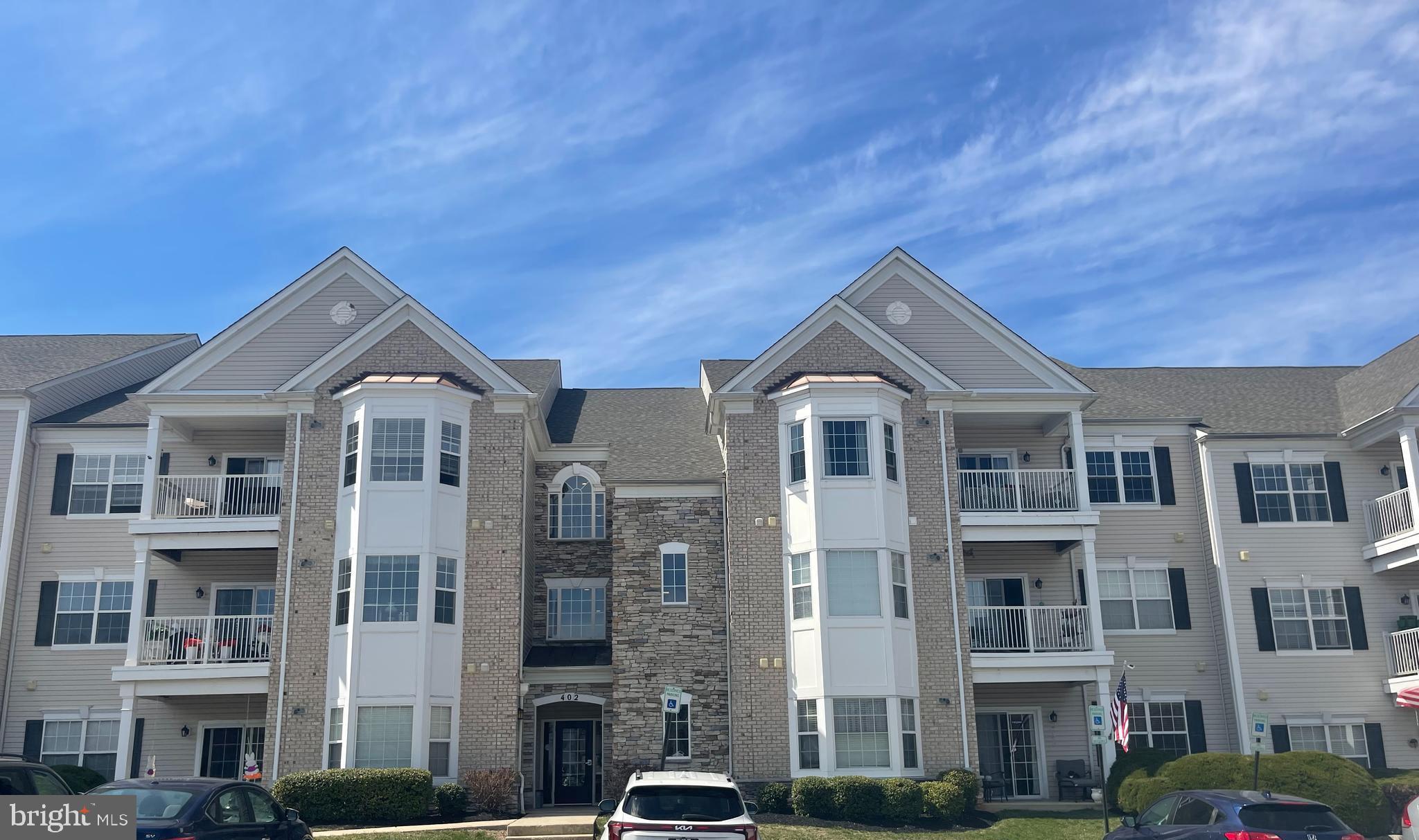 402 Aggies Circle, Unit L Bel Air, MD 21014 - Photo 19 of 23 a front view of a residential apartment building with a yard