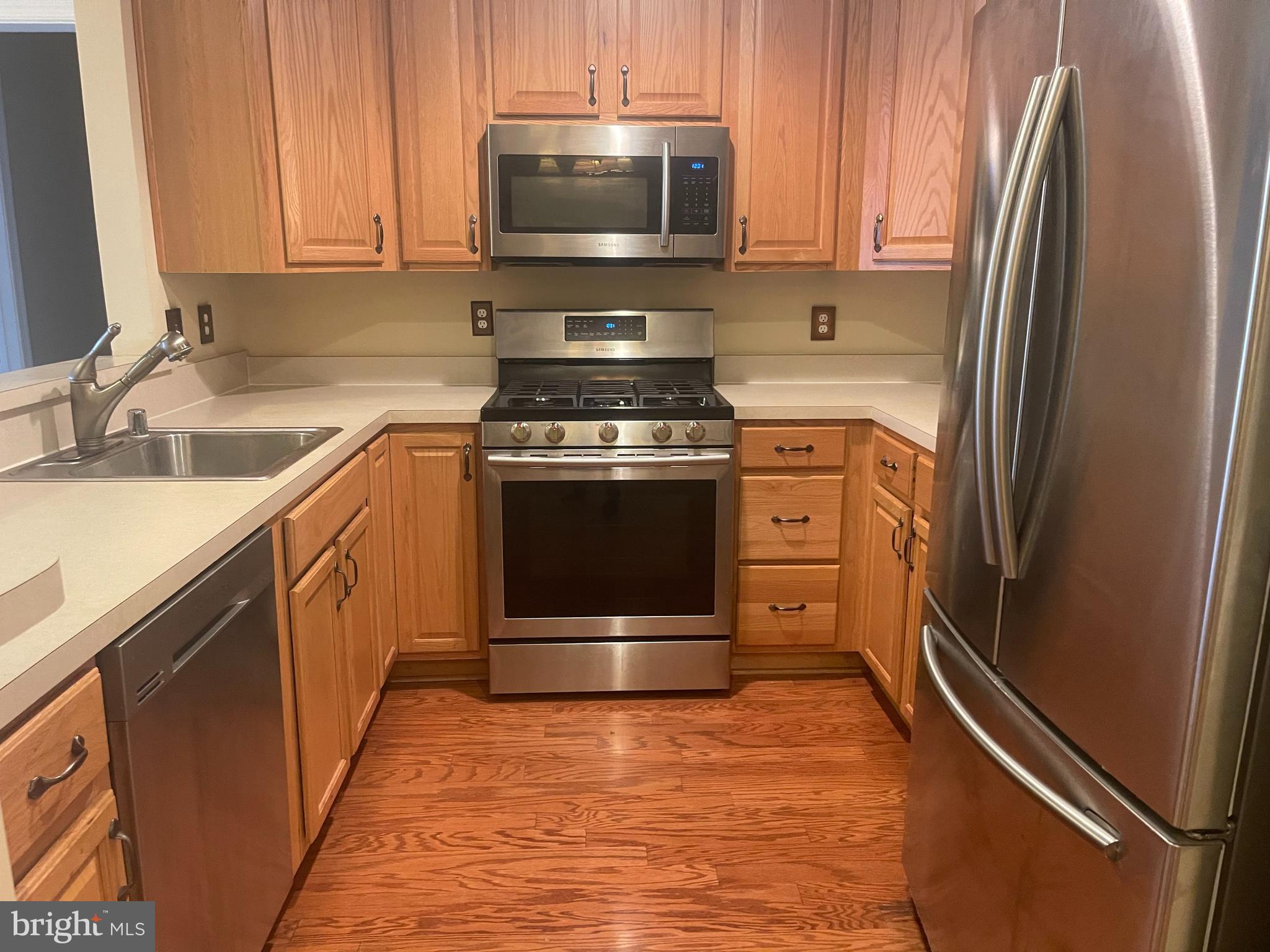 402 Aggies Circle, Unit L Bel Air, MD 21014 - Photo 4 of 23 a kitchen with stainless steel appliances granite countertop a refrigerator stove and sink