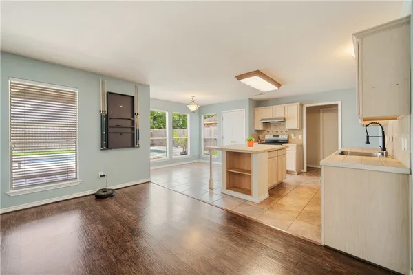 a kitchen with a refrigerator and a stove top oven