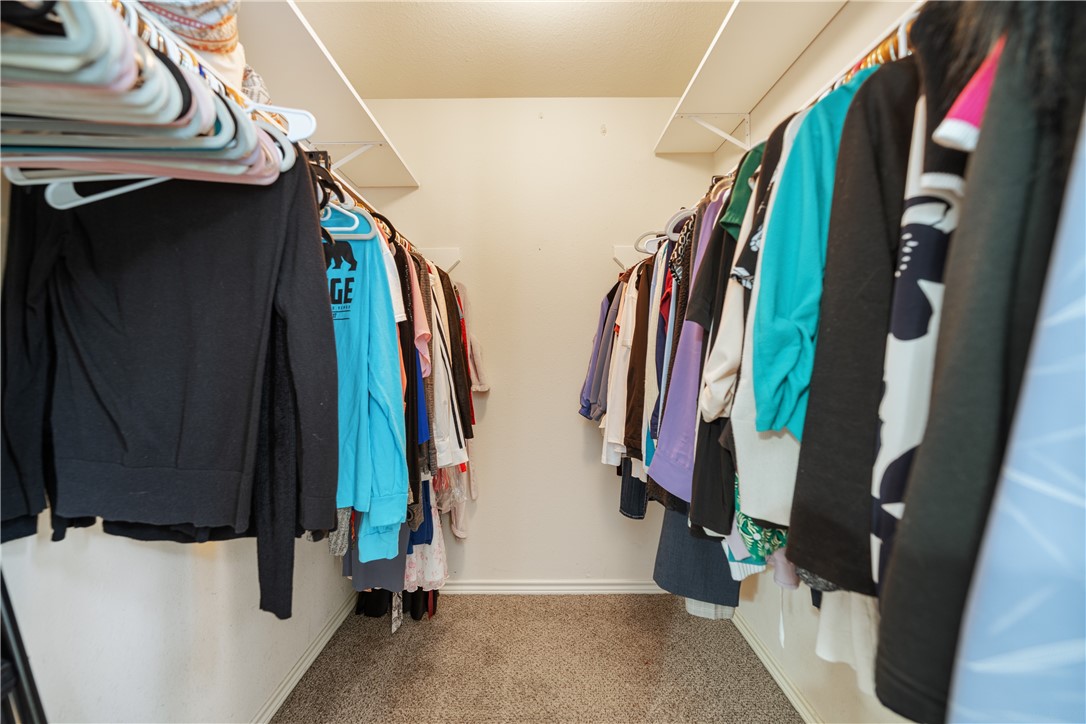 7630 Cedar Brook Drive Corpus Christi, TX 78413 - Photo 17 of 32 a view of walk in closet with clothes and shoes