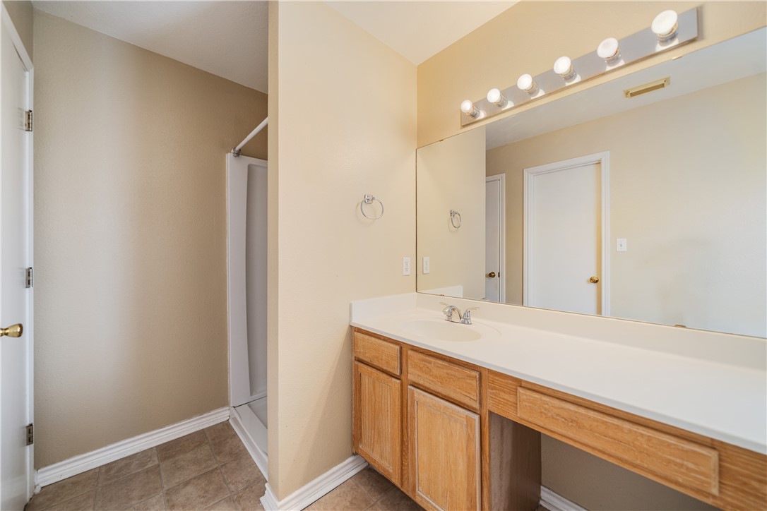 7630 Cedar Brook Drive Corpus Christi, TX 78413 - Photo 19 of 32 a bathroom with a sink a vanity and a mirror
