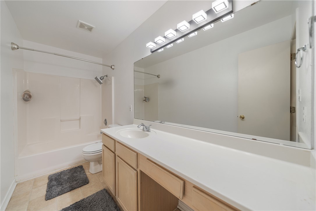 7630 Cedar Brook Drive Corpus Christi, TX 78413 - Photo 24 of 32 a bathroom with a sink a toilet a shower and a mirror